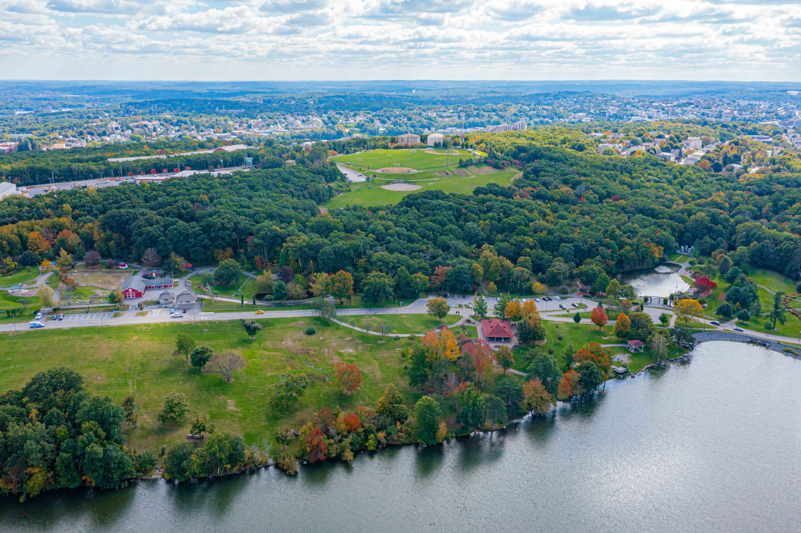 Aerial Shot of Green Hill Park with Cityscape